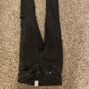 Black jeans with hole at knee